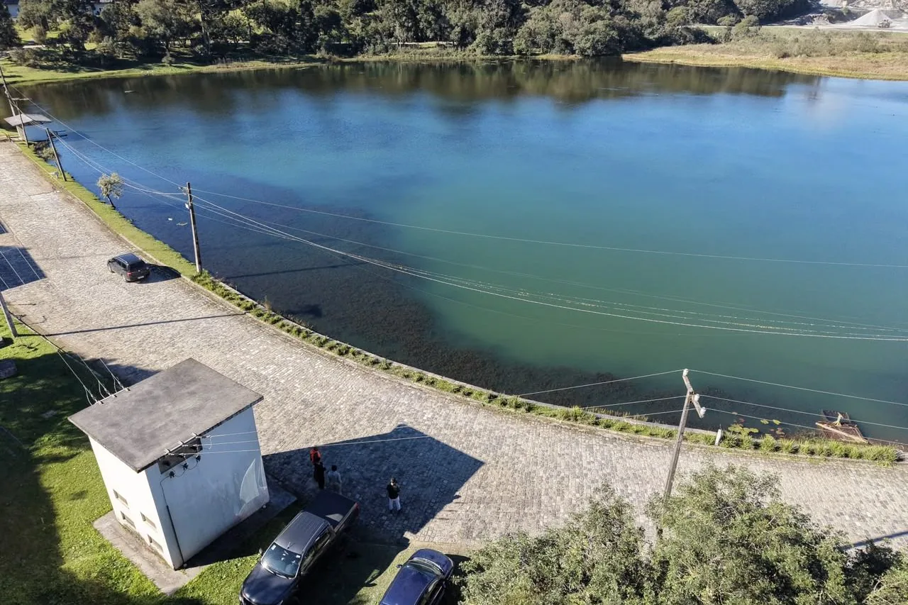 Barragem com crista pavimentada, casa de operação e reservatório
